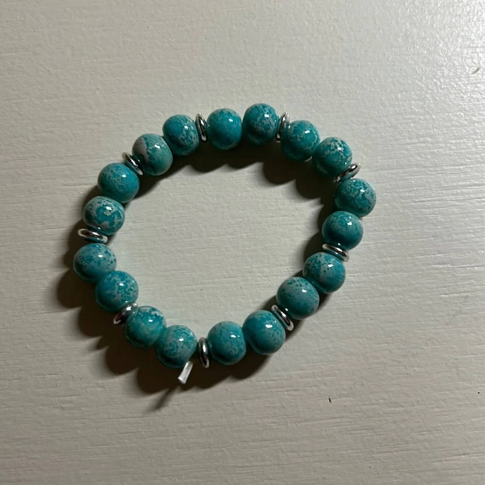 Kids blue with silver accent beads stretchy bracelet. Measure 2.5” Gently used.